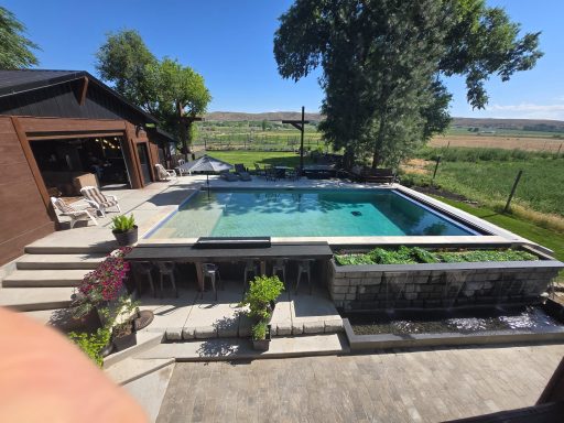 Backyard Views & Poolside Peace Modern backyard with a swimming pool, surrounded by greenery and outdoor seating.