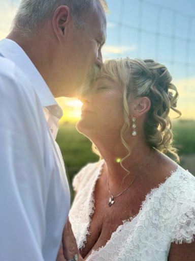 Golden Hour Kiss Couple sharing a romantic kiss at sunset, with the sun glowing behind them.