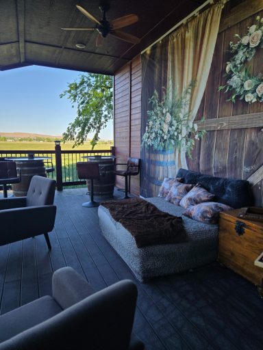 Rustic Retreat with a View Cozy outdoor seating area with a scenic view and floral wall decor.